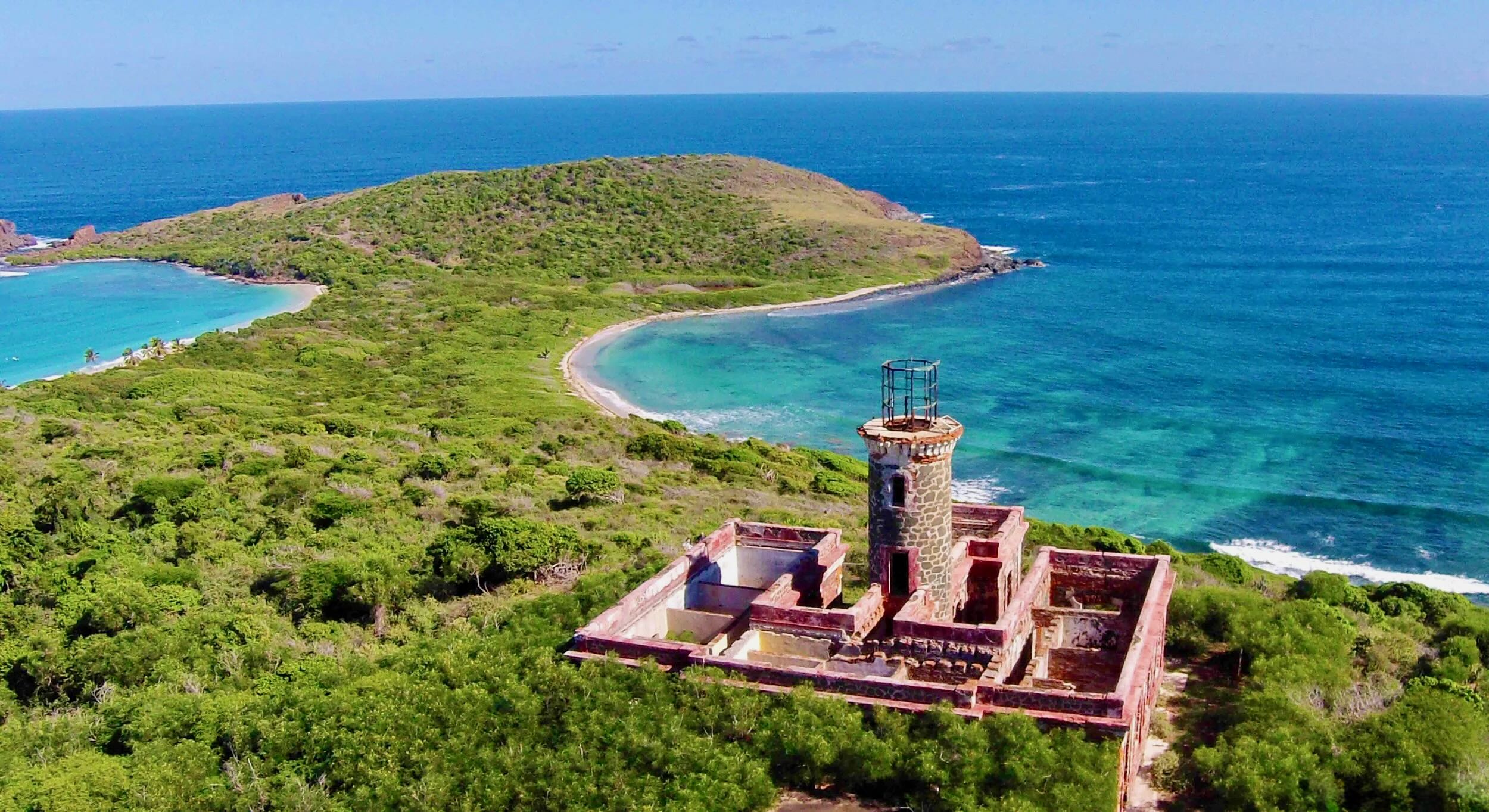 Aerial view of Cayo Culebrita, a small green island ringed by reefs and turquoise water